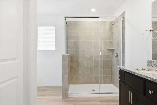 a bathroom with a shower and a sink