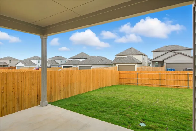 a view of a backyard with plants and a lake view