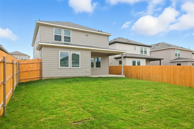 a view of a backyard with plants and a lake view