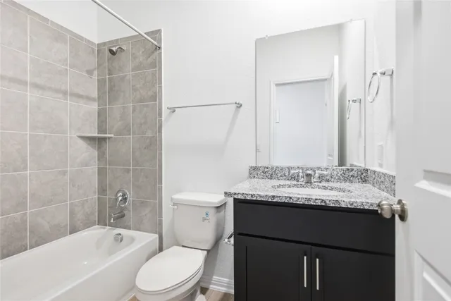 a bathroom with a sink toilet vanity and shower