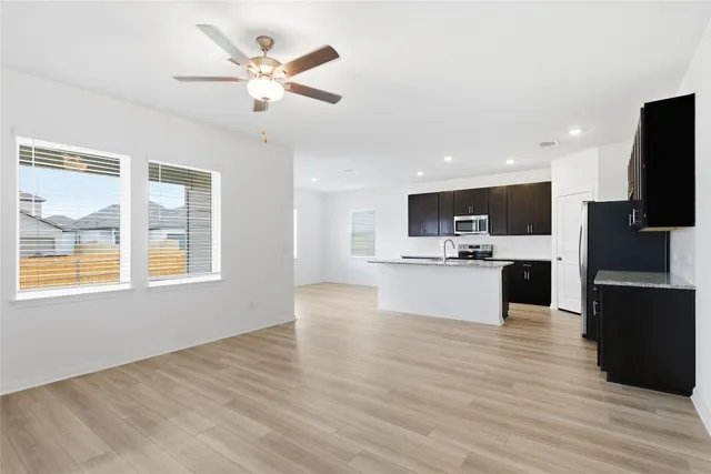 a view of kitchen with microwave a refrigerator and microwave