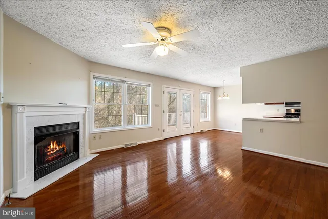 a kitchen with stainless steel appliances granite countertop a sink a stove and a wooden floors