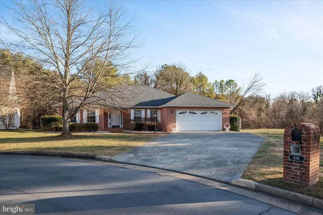 a view of a large house with a big yard and large trees