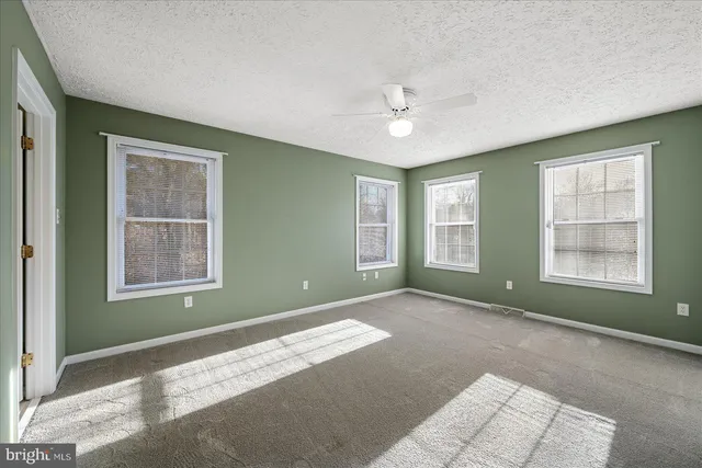 an empty room with closet area and bathroom