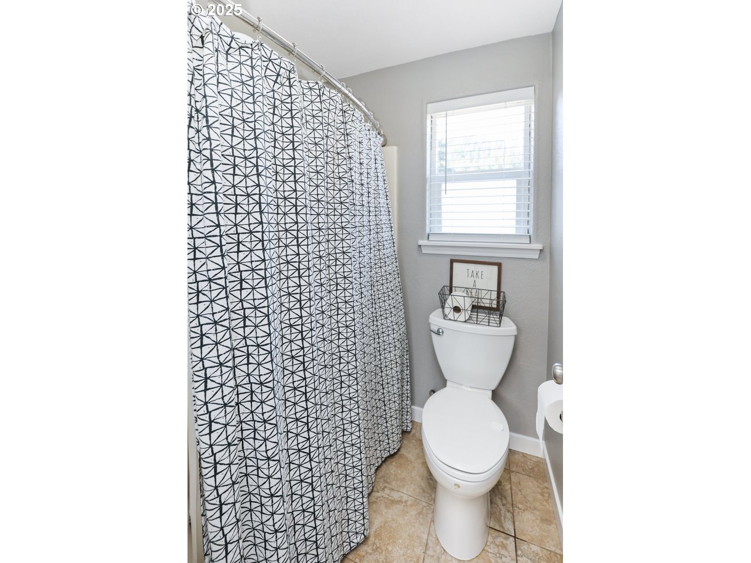701 South 68th Place Springfield, OR 97478 - Photo 20 of 28 a bathroom with a toilet and a shower curtain