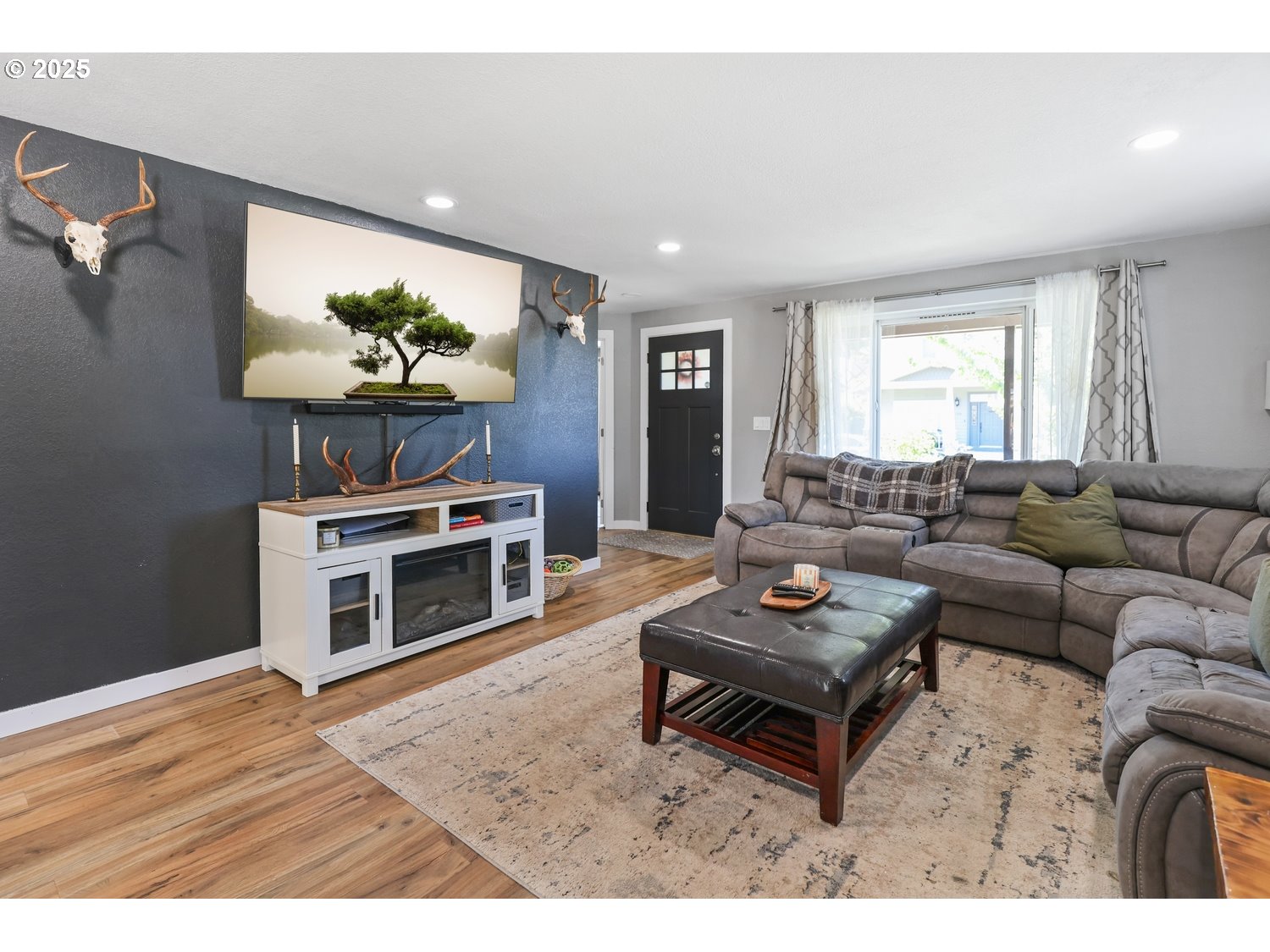 701 South 68th Place Springfield, OR 97478 - Photo 4 of 28 a living room with furniture a fireplace and a flat screen tv
