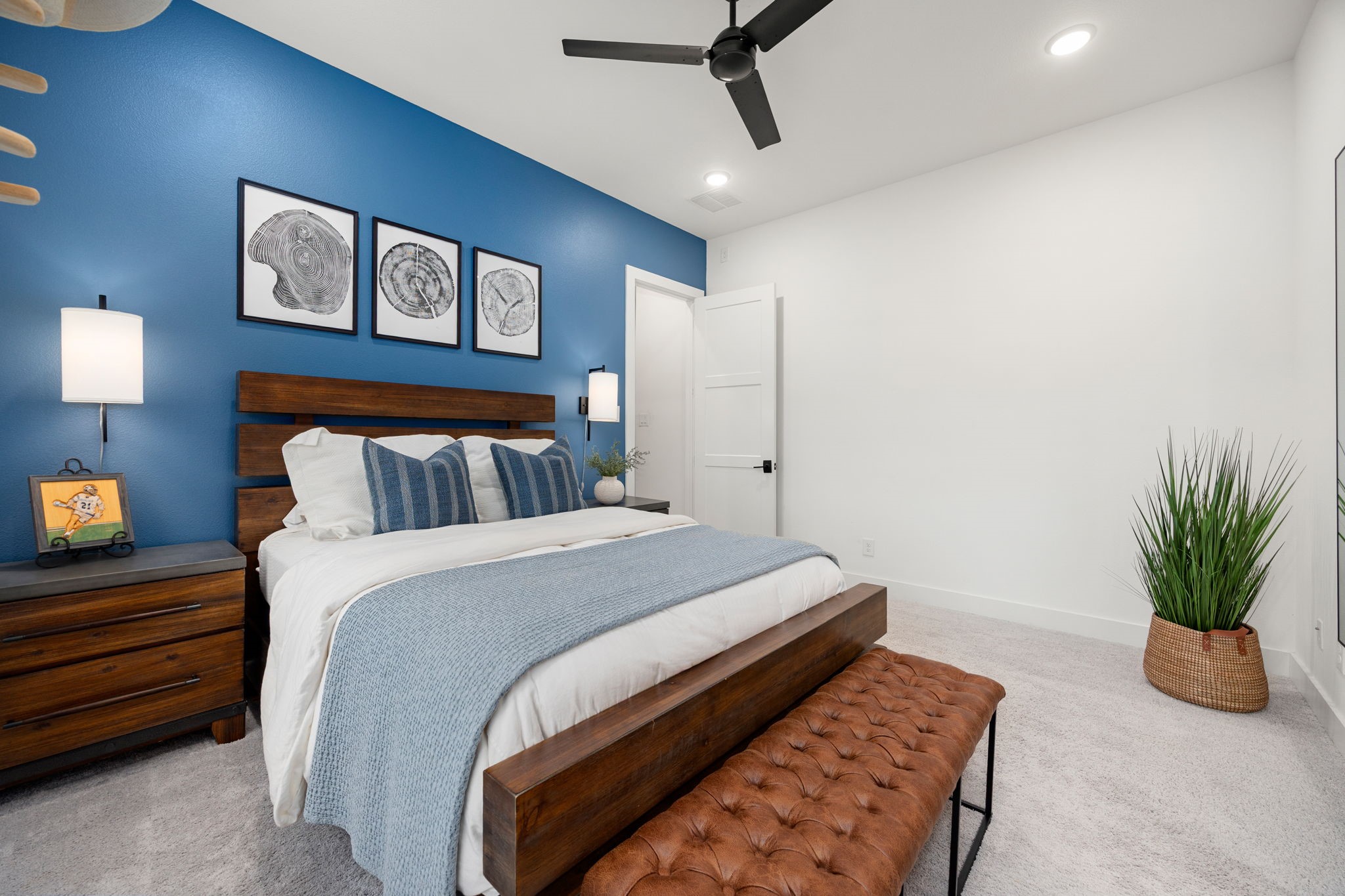 27903 Indigo Ridge Drive Fulshear, TX 77441 - Photo 35 of 50 Comfortable secondary bedroom featuring a bold accent wall, modern finishes, and ample space for family or guests.
