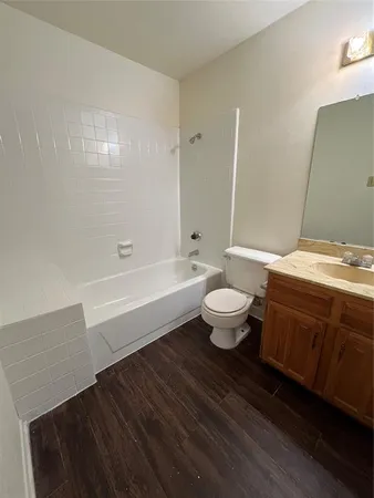 a bathroom with a toilet a sink and bathtub