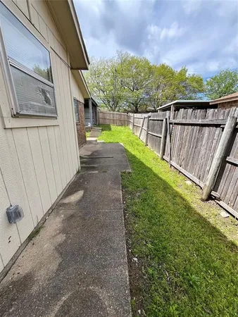 a view of a pathway of a house with a backyard