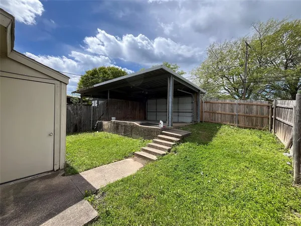 a front view of a house with a yard table and chairs