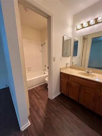 a bathroom with a double vanity sink and mirror with shower