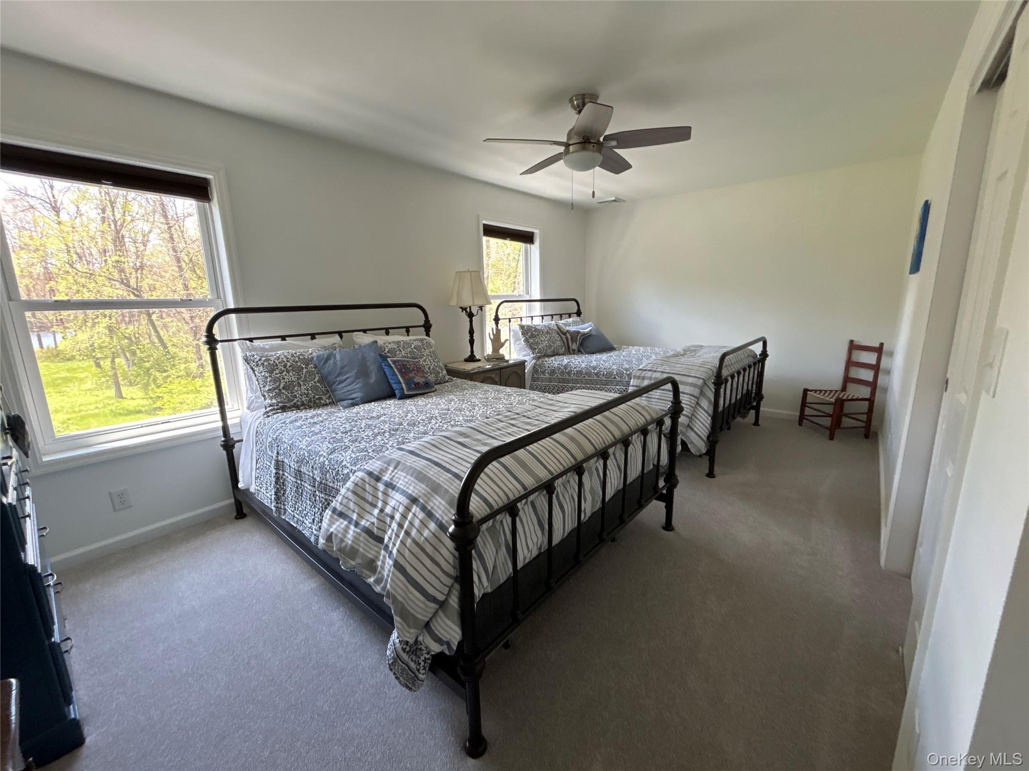 382 Sharon Station Road Amenia, NY 12501 - Photo 13 of 21 a bedroom with a bed a chandelier and dresser