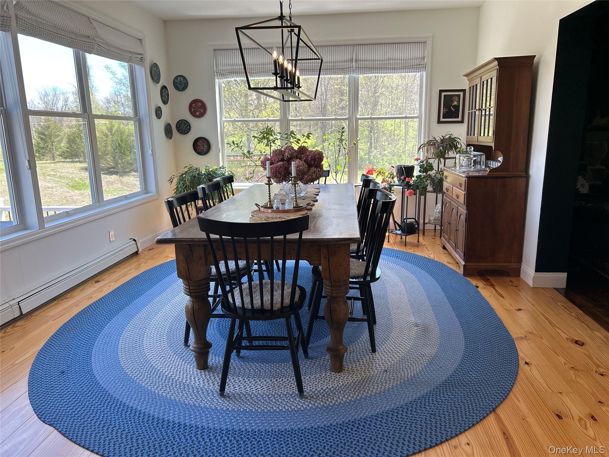 382 Sharon Station Road Amenia, NY 12501 - Photo 6 of 21 a dining room with furniture a chandelier and wooden floor