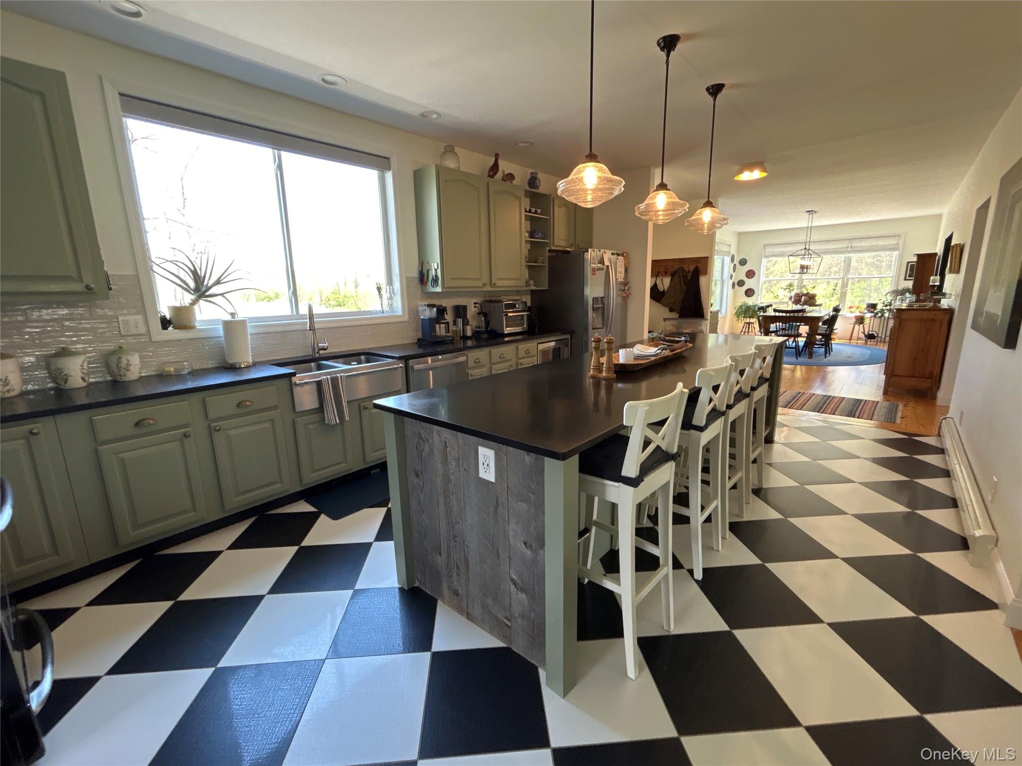 382 Sharon Station Road Amenia, NY 12501 - Photo 7 of 21 a kitchen with stainless steel appliances granite countertop a sink a stove a dining table chair and a chandelier