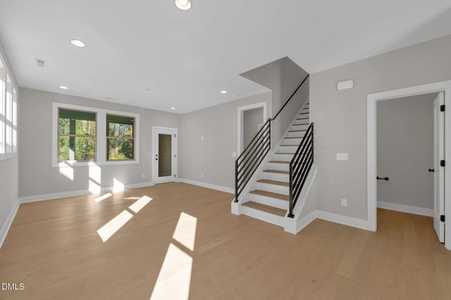 a view of an empty room with stairs and ventilation