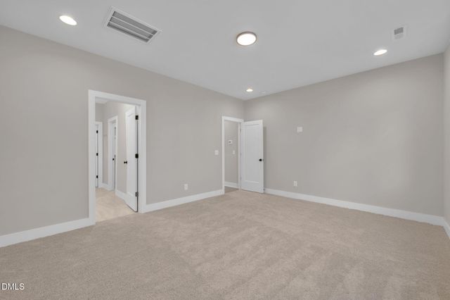 an empty room with an entryway and closet area