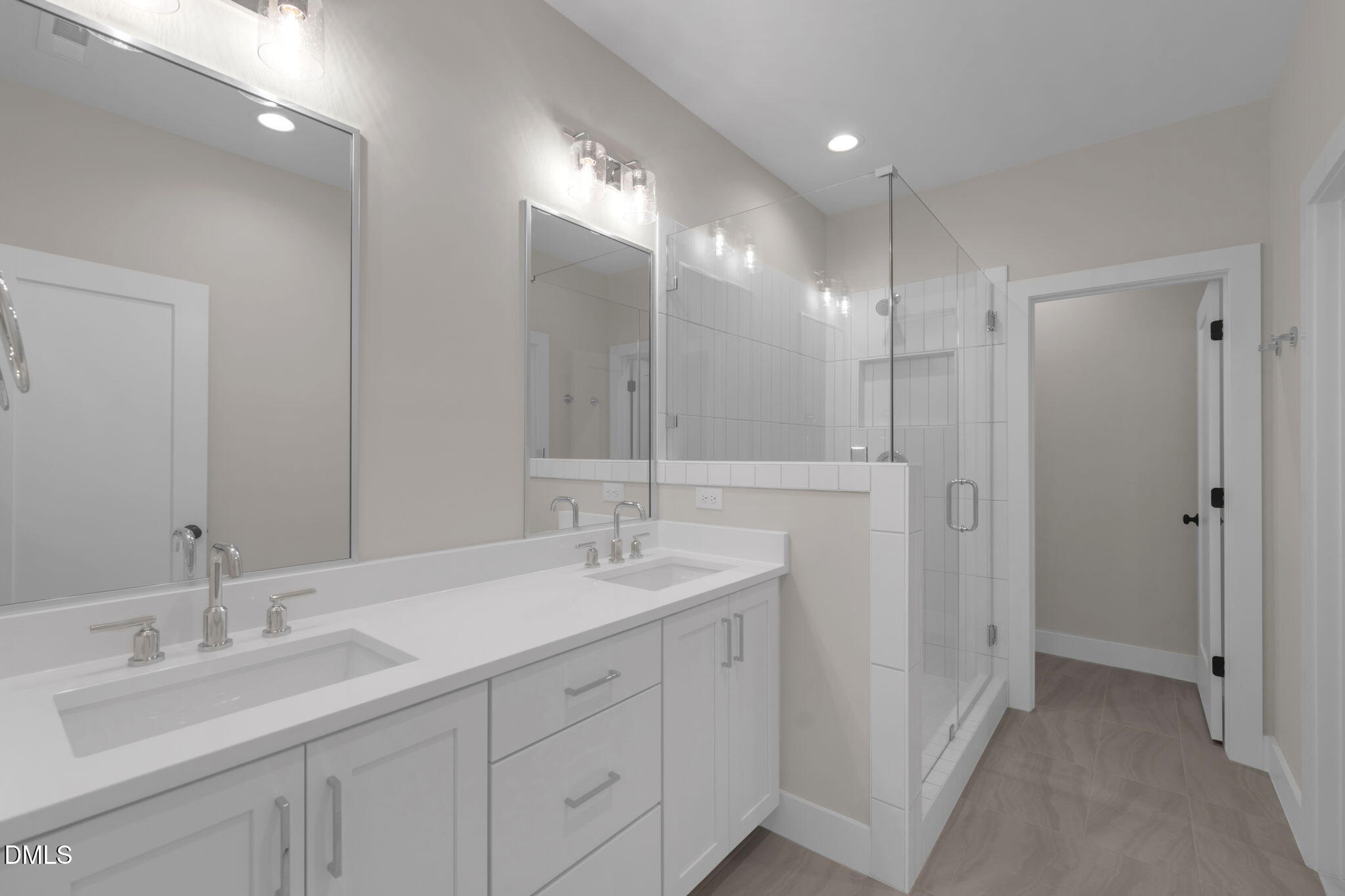 974 Double Helix Road Apex, NC 27523 - Photo 20 of 52 a bathroom with double sink and a mirror