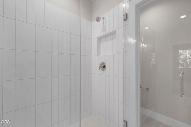 a bathroom with a shower and a glass door