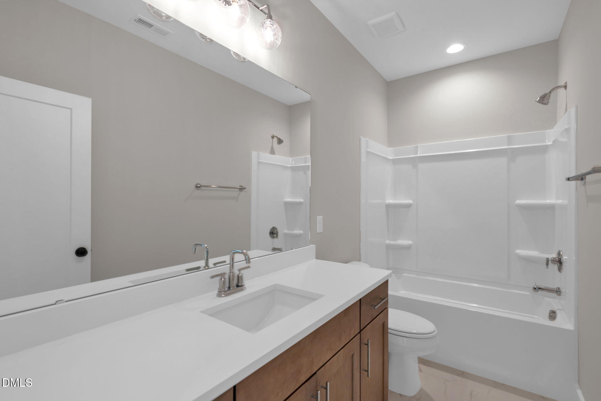 974 Double Helix Road Apex, NC 27523 - Photo 28 of 52 a bathroom with a sink a toilet and shower