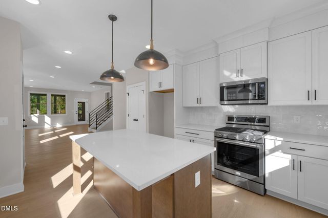 a kitchen with a stove a sink and a refrigerator