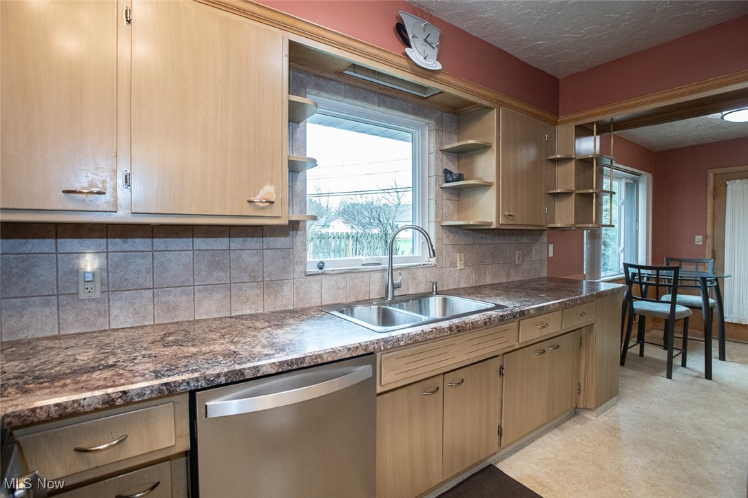 13740 Old Pleasant Valley Road Cleveland, OH 44130 - Photo 9 of 28 Kitchen featuring a sink, open shelves, tasteful backsplash, dishwasher, and a textured ceiling