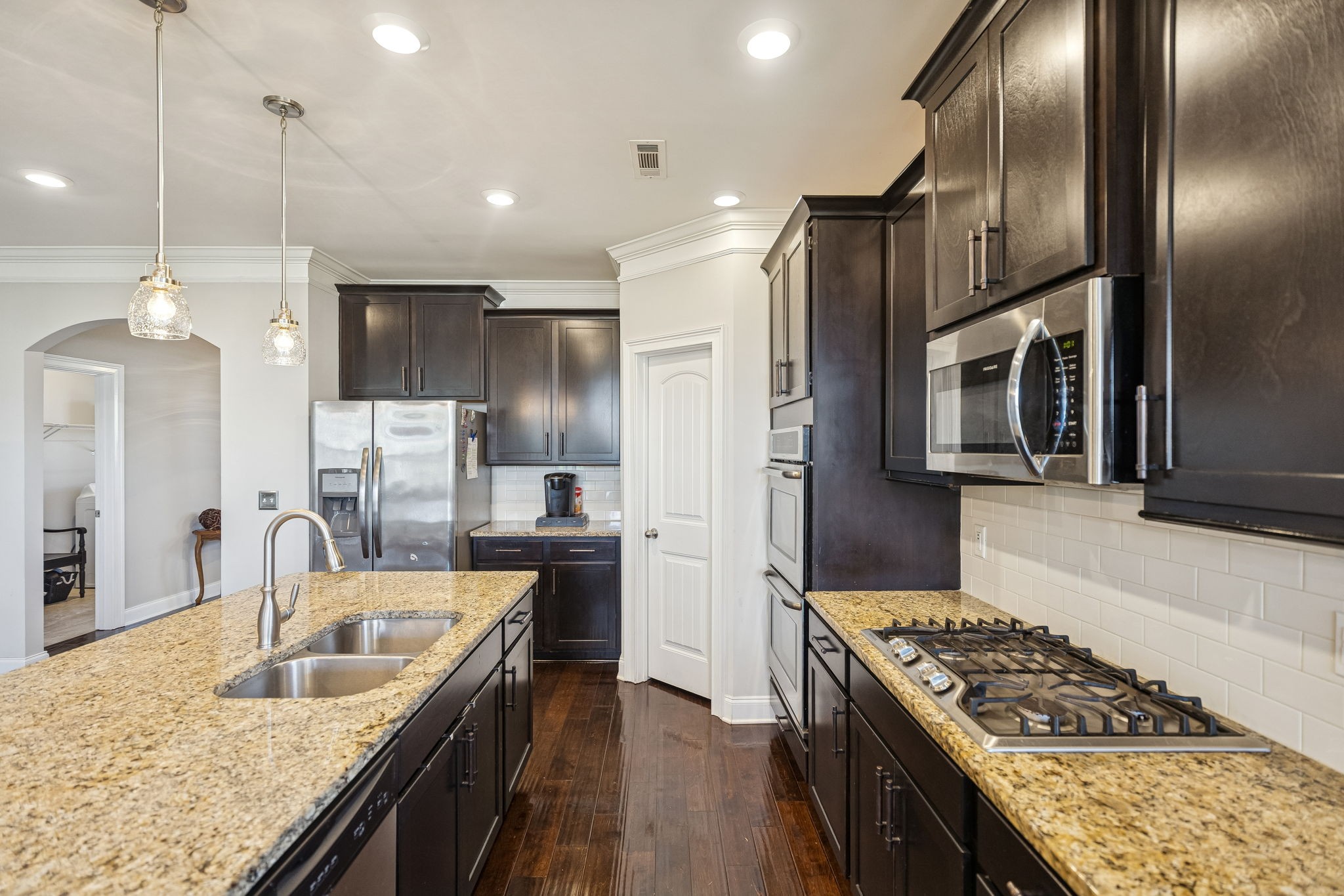 1167 Batbriar Road Murfreesboro, TN 37128 - Photo 7 of 22 a kitchen with granite countertop a sink stainless steel appliances and cabinets