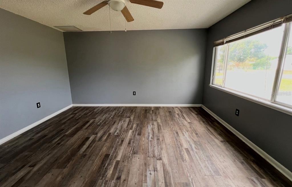 7670 Southwest 112th Lane Ocala, FL 34476 - Photo 4 of 16 a view of a room with wooden floor and windows