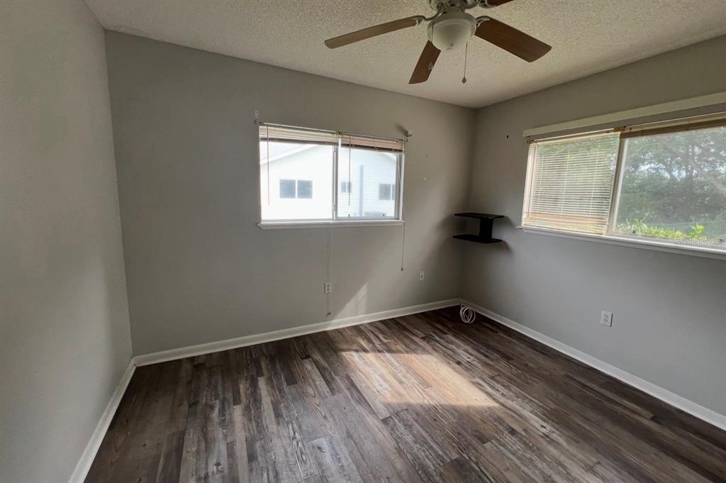 7670 Southwest 112th Lane Ocala, FL 34476 - Photo 8 of 16 wooden floor in an empty room with a window