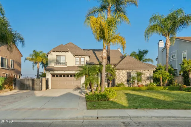 a view of a big building with a big yard and palm trees