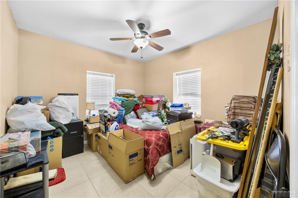 304 South 27th Street McAllen, TX 78501 - Photo 11 of 21 a bed room with a bed mirror and a window