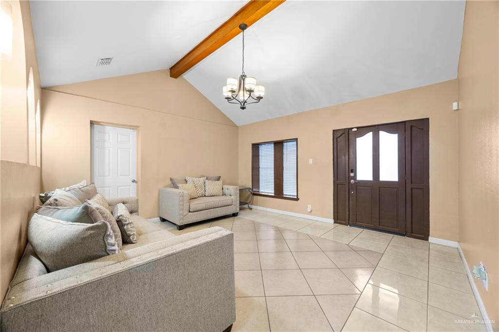 304 South 27th Street McAllen, TX 78501 - Photo 2 of 21 a bedroom with furniture and a chandelier
