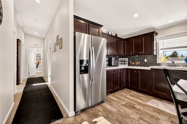 a kitchen with stainless steel appliances a refrigerator and a stove top oven