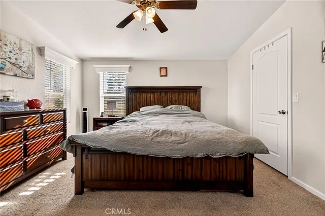 a bed sitting in a bedroom next to a window