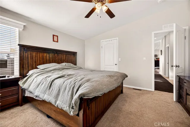 a bed sitting in a bedroom next to a window