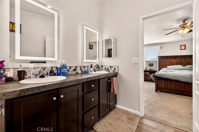 a en suite bathroom with a sink double vanity and a mirror