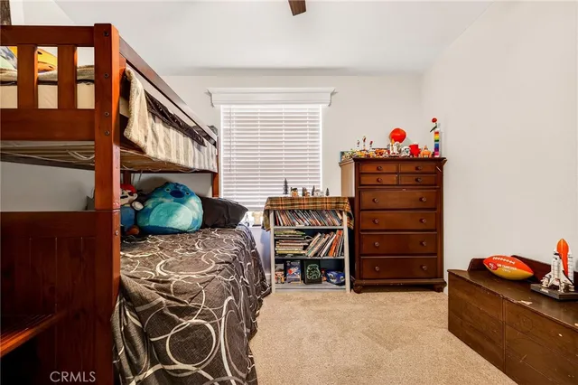 a bedroom with a bed and a potted plant