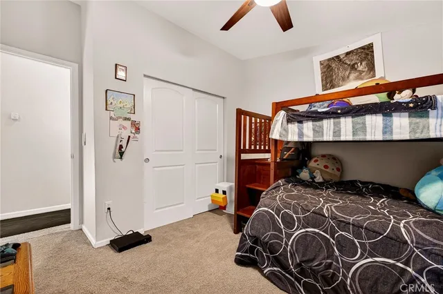 a bathroom with a granite countertop sink a toilet a mirror a bathtub and shower