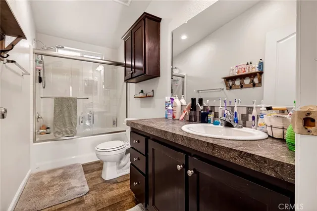 a view of hallway with wooden floor and stairs