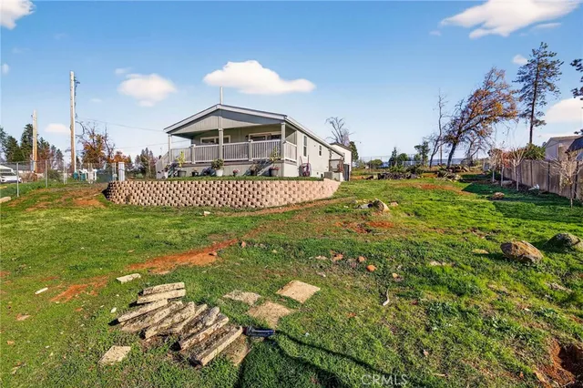 a backyard of a house with table and chairs