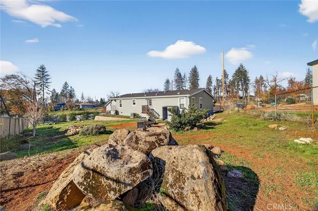 a view of a house with backyard and sitting area