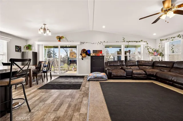 a living room with lots of furniture and kitchen view
