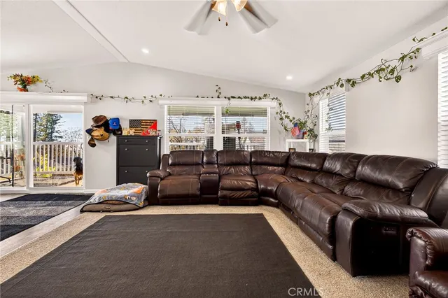 a living room with furniture gym equipment and a chandelier