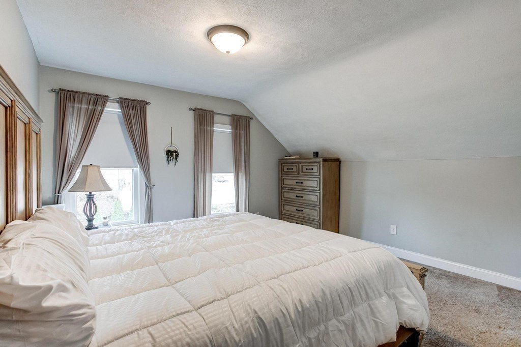 54 Pine Street Stoneham, MA 02180 - Photo 20 of 30 a bedroom with a large bed and a window