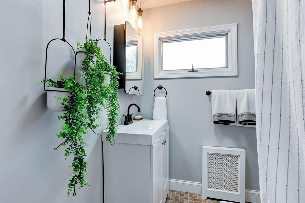 54 Pine Street Stoneham, MA 02180 - Photo 21 of 30 a bathroom with a sink and mirror