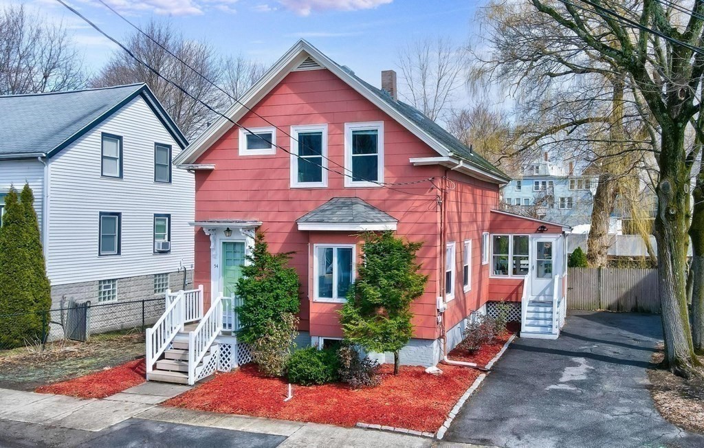 54 Pine Street Stoneham, MA 02180 - Photo 24 of 30 a front view of a house with a yard