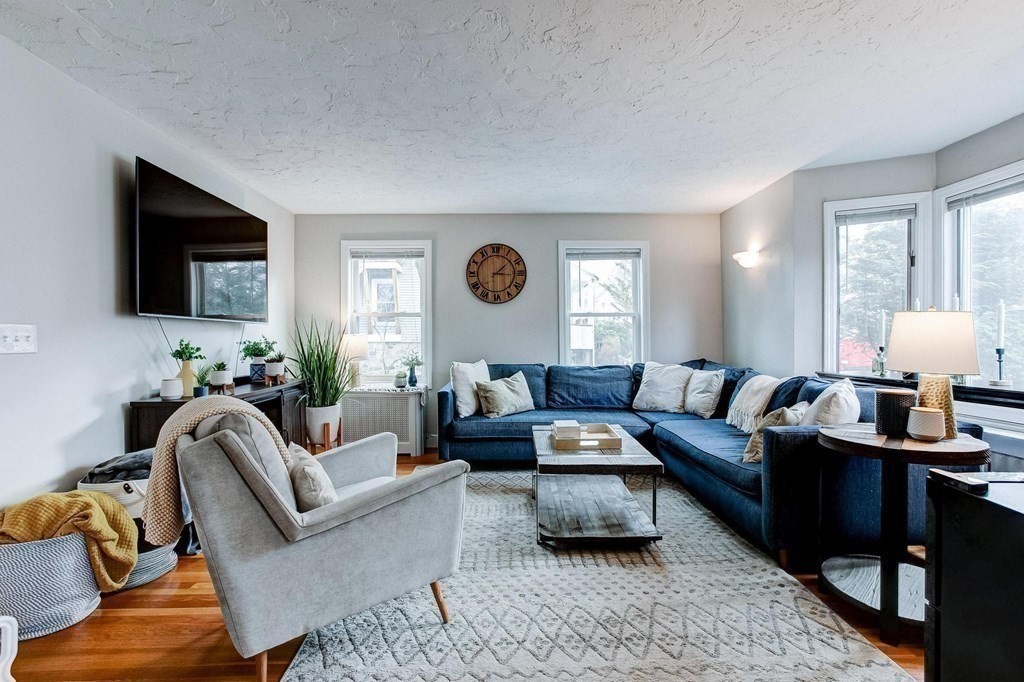 54 Pine Street Stoneham, MA 02180 - Photo 4 of 30 a living room with furniture and a flat screen tv