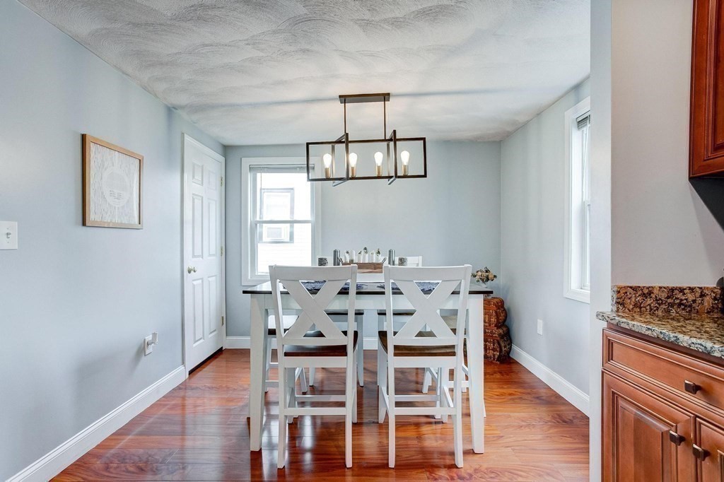 54 Pine Street Stoneham, MA 02180 - Photo 7 of 30 a view of a dining room with furniture window and wooden floor