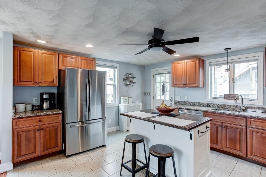 54 Pine Street Stoneham, MA 02180 - Photo 8 of 30 a kitchen with a refrigerator and a sink