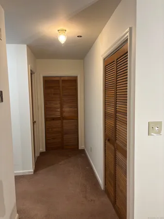 an empty room with closet and bathroom