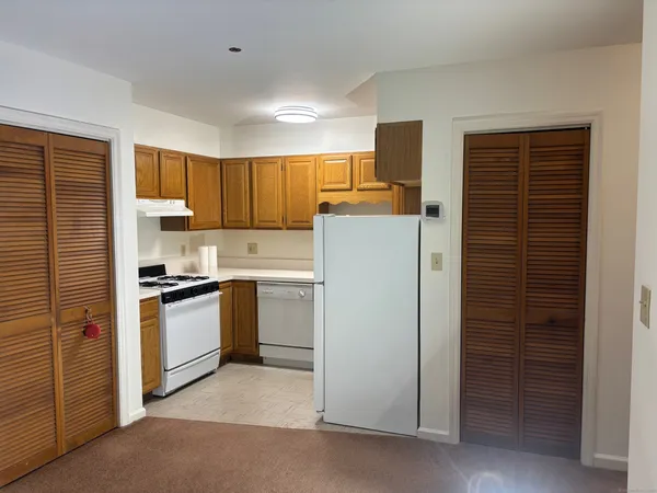 a kitchen with refrigerator and cabinets